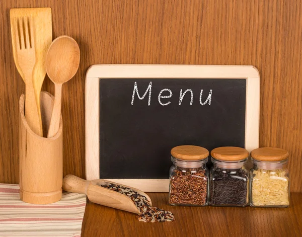 Menu board and wooden spoons and fork, and different varieties o Stock Image