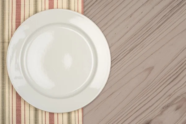 Placa branca vazia na mesa de madeira — Fotografia de Stock
