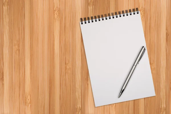 Blank notepad with pen on office wooden table — Stock Photo, Image