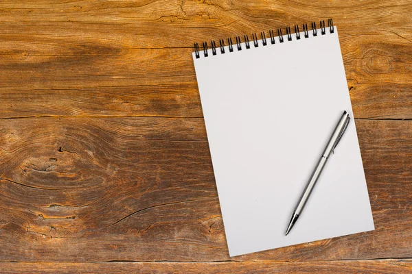 Blank notepad with pen on office wooden table — Stock Photo, Image