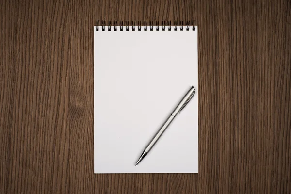 Blank notepad with pen on office wooden table — Stock Photo, Image
