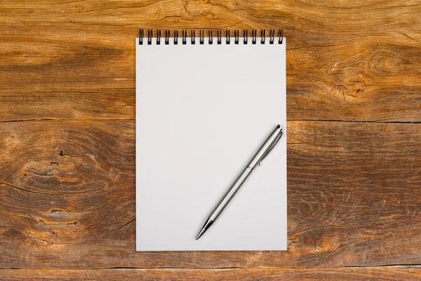 Blank notepad with pen on office wooden table — Stock Photo, Image