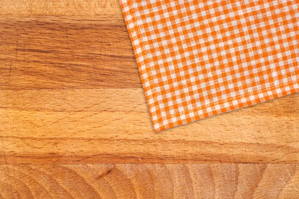 Rustic wooden boards with a orange checkered tablecloth — Stock Photo, Image