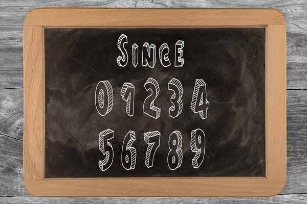 Since 0123456789 - chalkboard with 3D outlined text - on wood — Stock Photo, Image