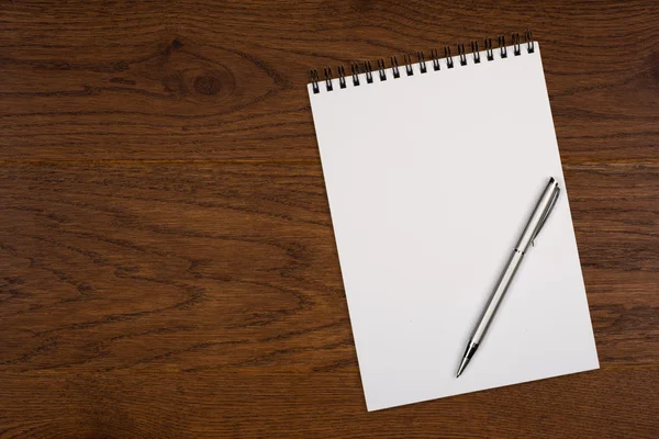 Blank notepad with pen on office wooden table — Stock Photo, Image