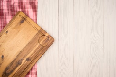 Empty cutting board on planks food background concept clipart