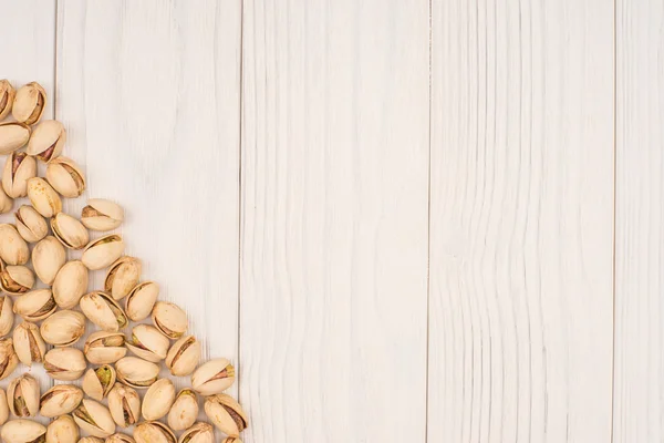 Roasted pistache nuts on natural wooden table background, healt — Fotografia de Stock