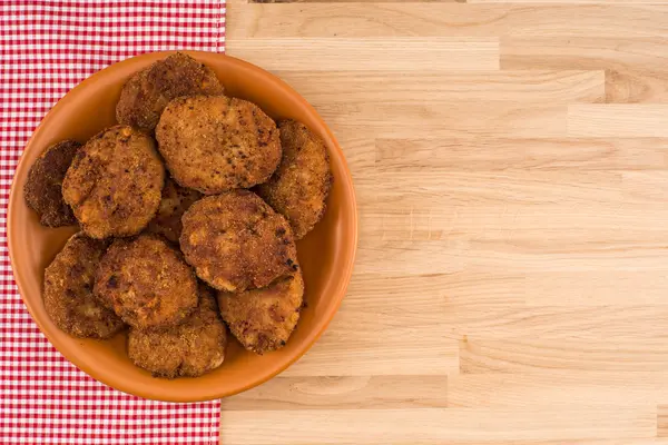Fried cutlet in the plate on wooden table — Stock Photo, Image