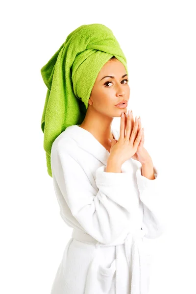 Woman in bathrobe clenching hands — Stock Photo, Image