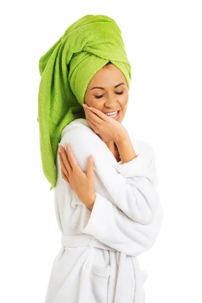 Woman in bathrobe touching face — Stock Photo, Image