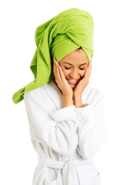 Woman in bathrobe touching face — Stock Photo, Image
