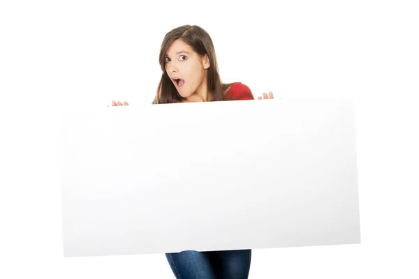 Shocked woman holding empty banner. — Stock Photo, Image