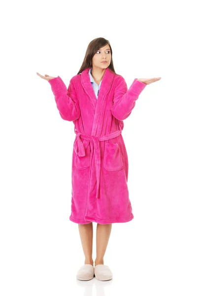 Woman in pink bathrobe showing empty palms. — Stock Photo, Image