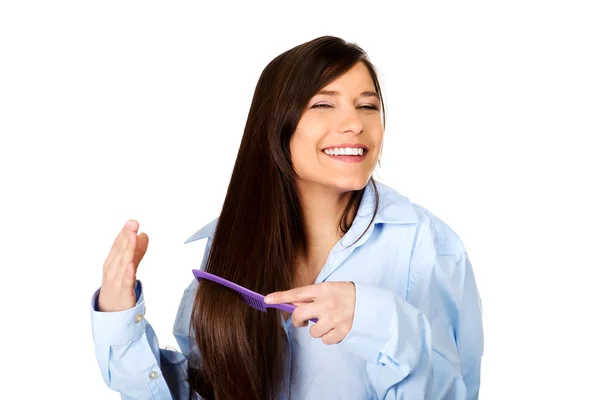 Morning woman in big shirt combing hair. — Stock Photo, Image