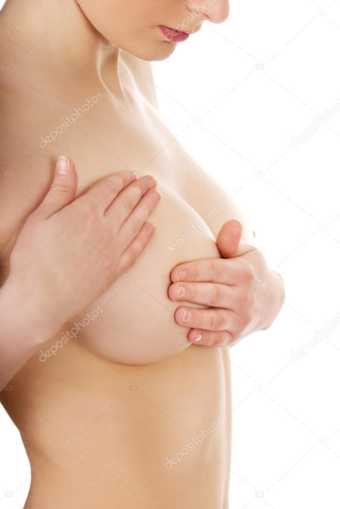 Woman examining breast.