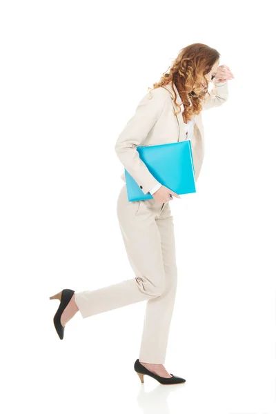 Tired businesswoman with binder. — Stock Photo, Image