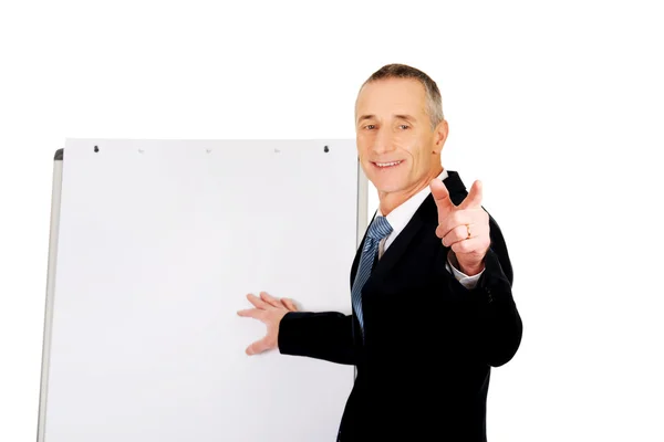 Male executive with marker pointing on someone — Stock Photo, Image