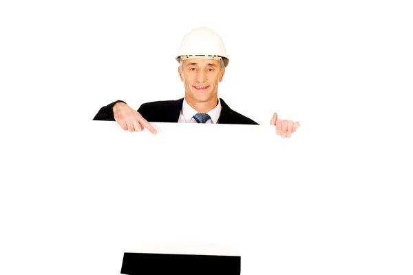 Businessman with hard hat holding empty banner — Stock Photo, Image
