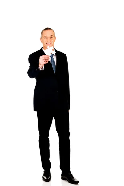 Smart businessman holding a puzzle — Stock Photo, Image