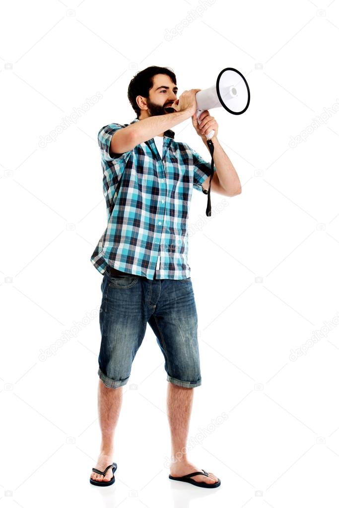 Young man shouting through megaphone.