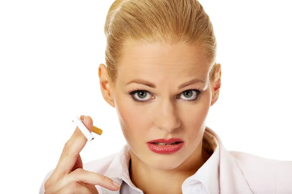 Business woman holding broken cigarette — Stock Photo, Image