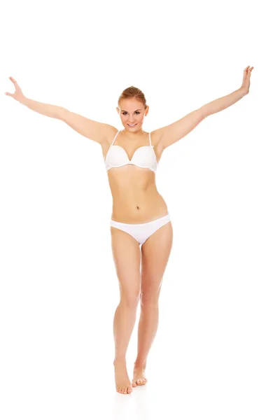 Happy young woman in white underwear holds her arms up — Stock Photo, Image