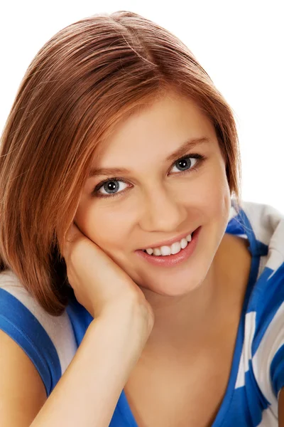 Smiling teenage woman sitting on a floor Royalty Free Stock Photos