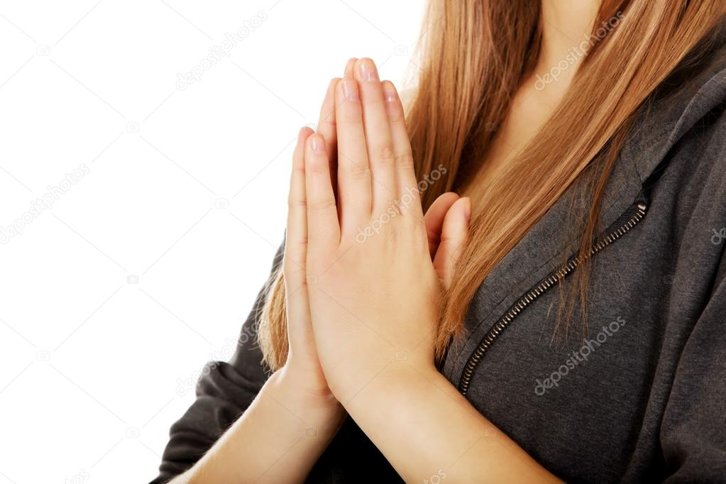 Teenage woman praying-religion concept