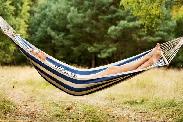 Young blonde woman resting on hammock — Stock Photo, Image