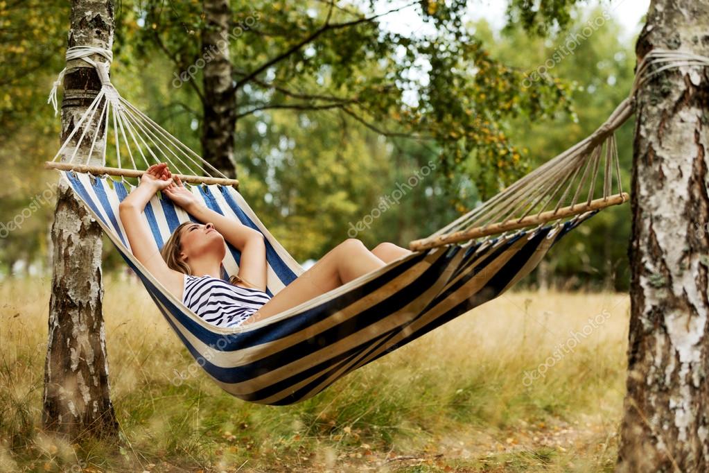 Young blonde woman resting on hammock — Stock Photo © piotr_marcinski #102833264