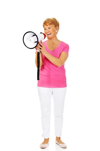 Senior sorrindo mulher gritando através de um megafone — Fotografia de Stock