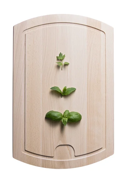 Leaves of lovage mint and basil on wooden board — Stock Photo, Image