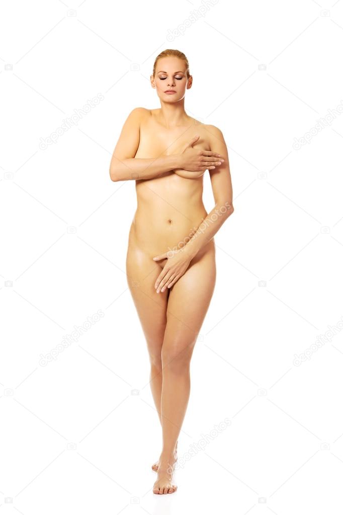 Attractive naked woman covering herself