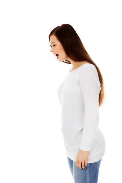 Angry young woman screaming for someone — Stock Photo, Image