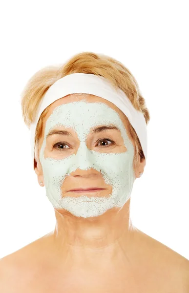 stock image Relaxed elderly woman in facial mask