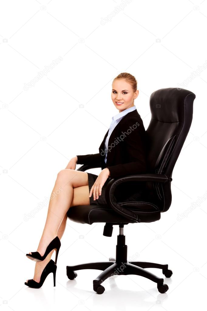 Young smile business woman sitting on a chair in office