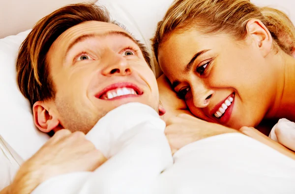 Woman whispering to her husband and he laughting — Stock Photo, Image