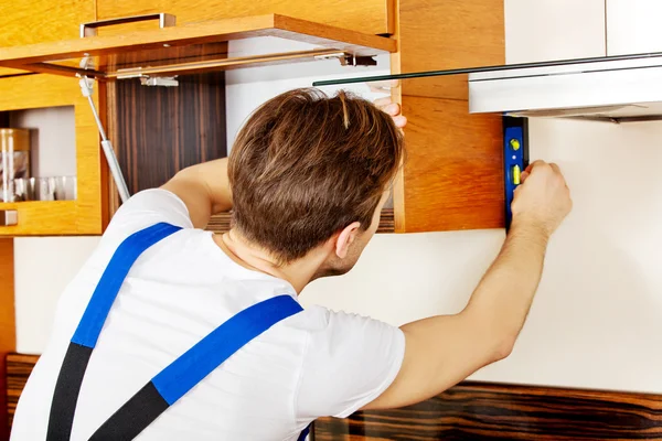 Young handyman with spirit level — Stock Photo, Image