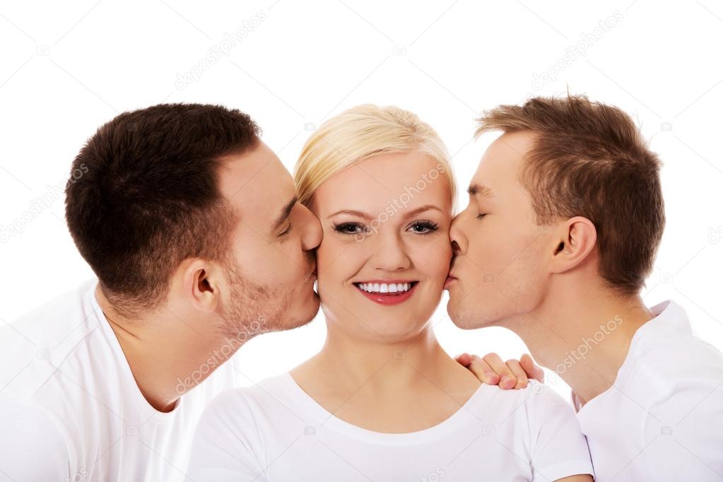 Two guys kissing friend woman cheeks