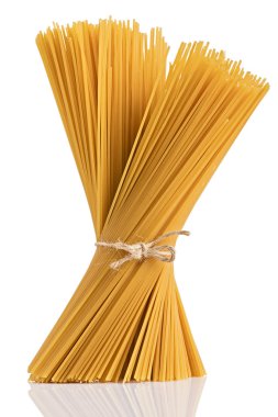 Uncooked dry fettuccine pasta isolated on a white background clipart