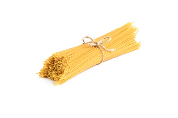 Uncooked dry fettuccine pasta isolated on a white background — Stock Photo, Image