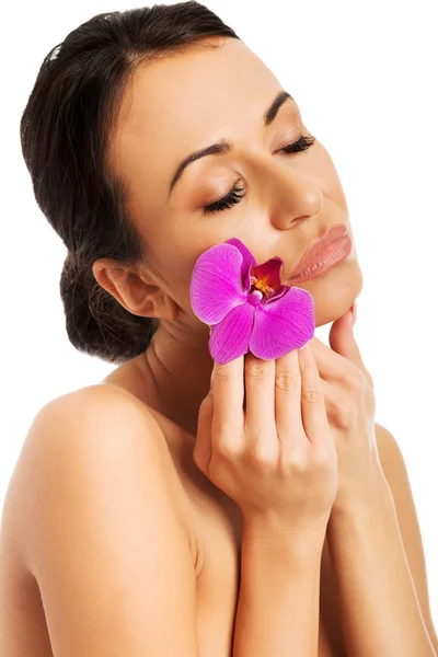 Woman with purple orchid and closed eyes — Stock Photo, Image