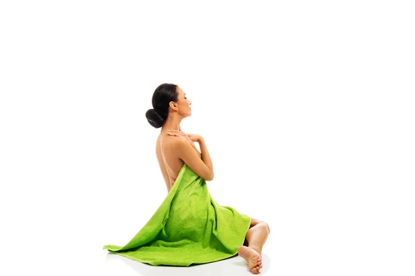 Woman sitting wrapped in towel — Stock Photo, Image