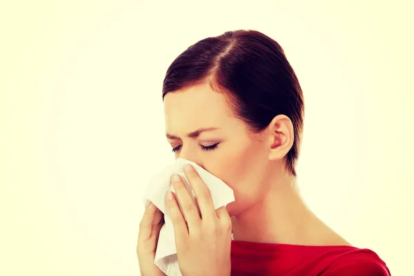 Young beautiful caucasian woman sneezing — Stock Photo, Image