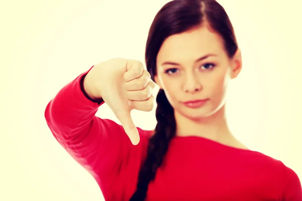 Joven mujer infeliz con el pulgar hacia abajo — Foto de Stock