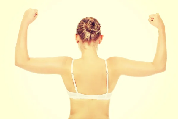 Back view of athletic woman show her muscles — Stock Photo, Image