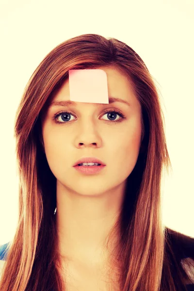 Teenage woman with sticky notes on forehead — Stock Photo, Image