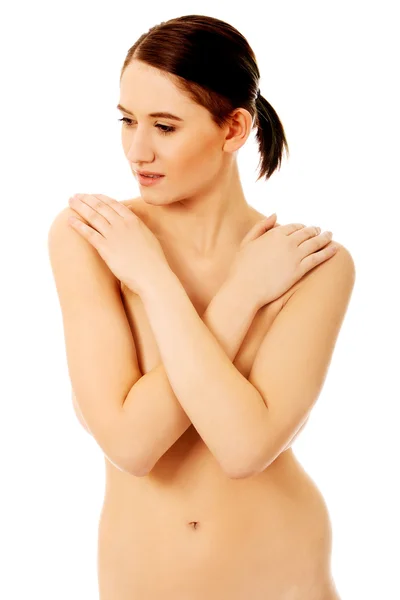 Slim naked woman covering her breast — Stock Photo, Image