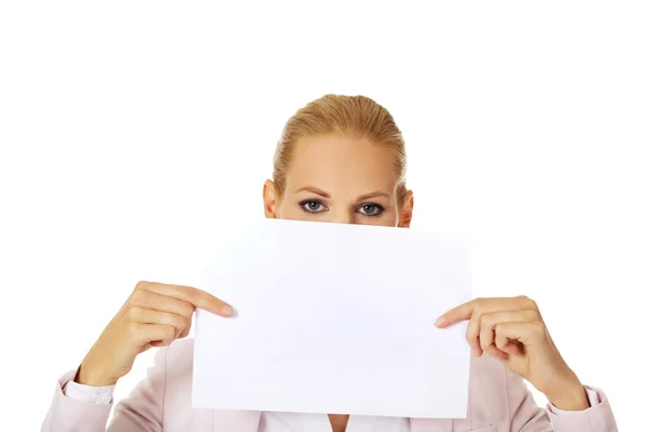 Business woman covering mouth and nose with blank paper sheet — Stock Photo, Image