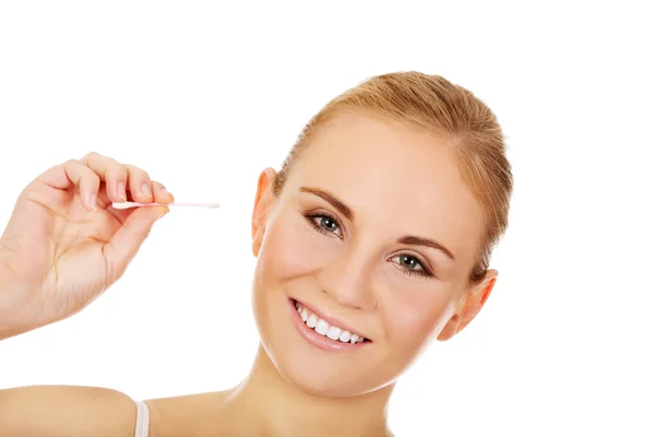 Young happy woman cleans her ear — Stock Photo, Image